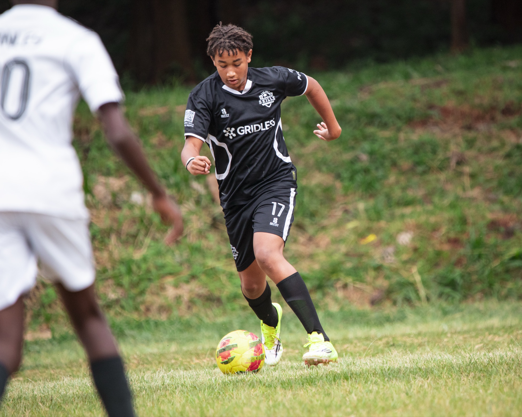 Skillz FC Academy player controlling the ball in a match