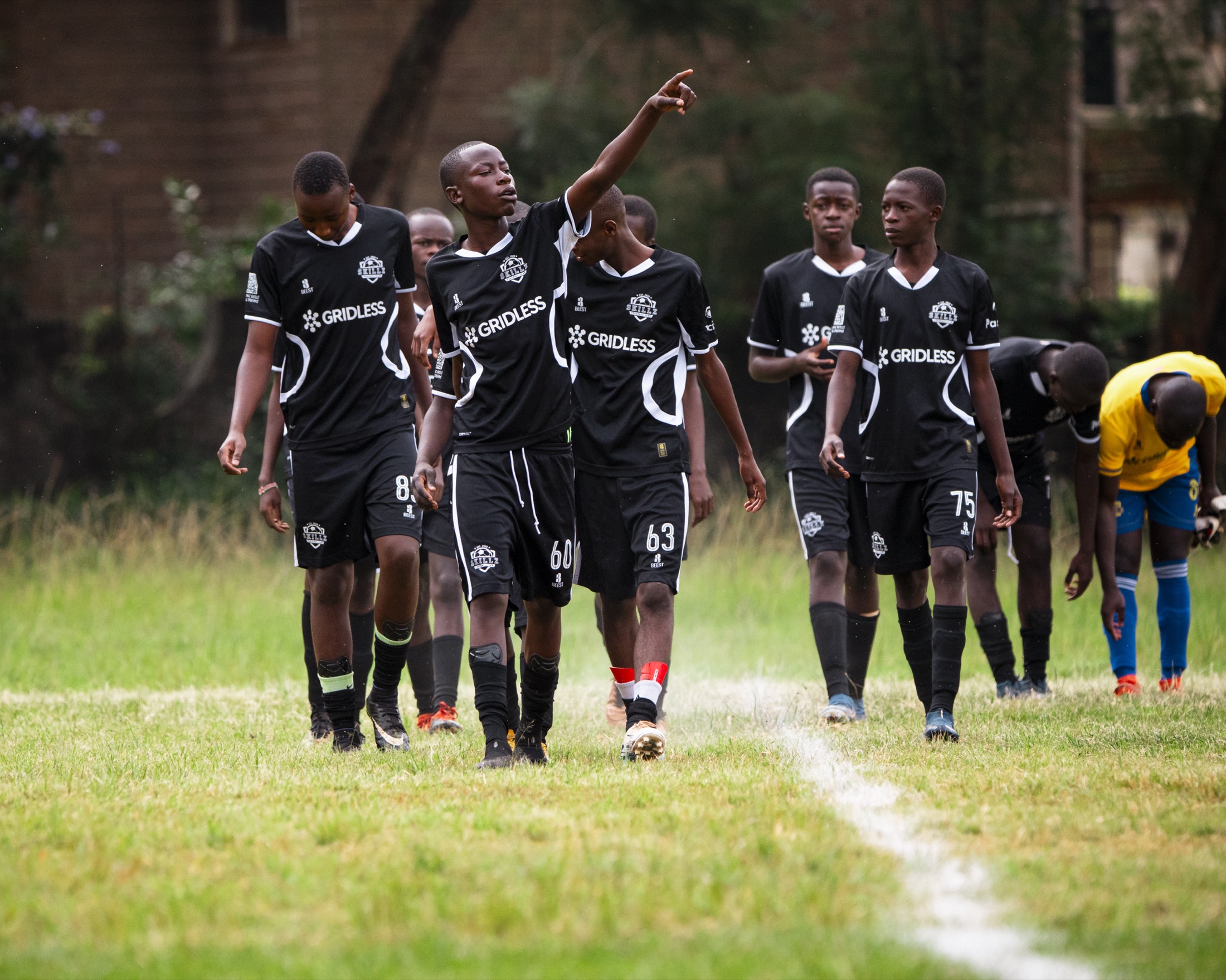 Skillz FC Academy players walking onto the pitch together